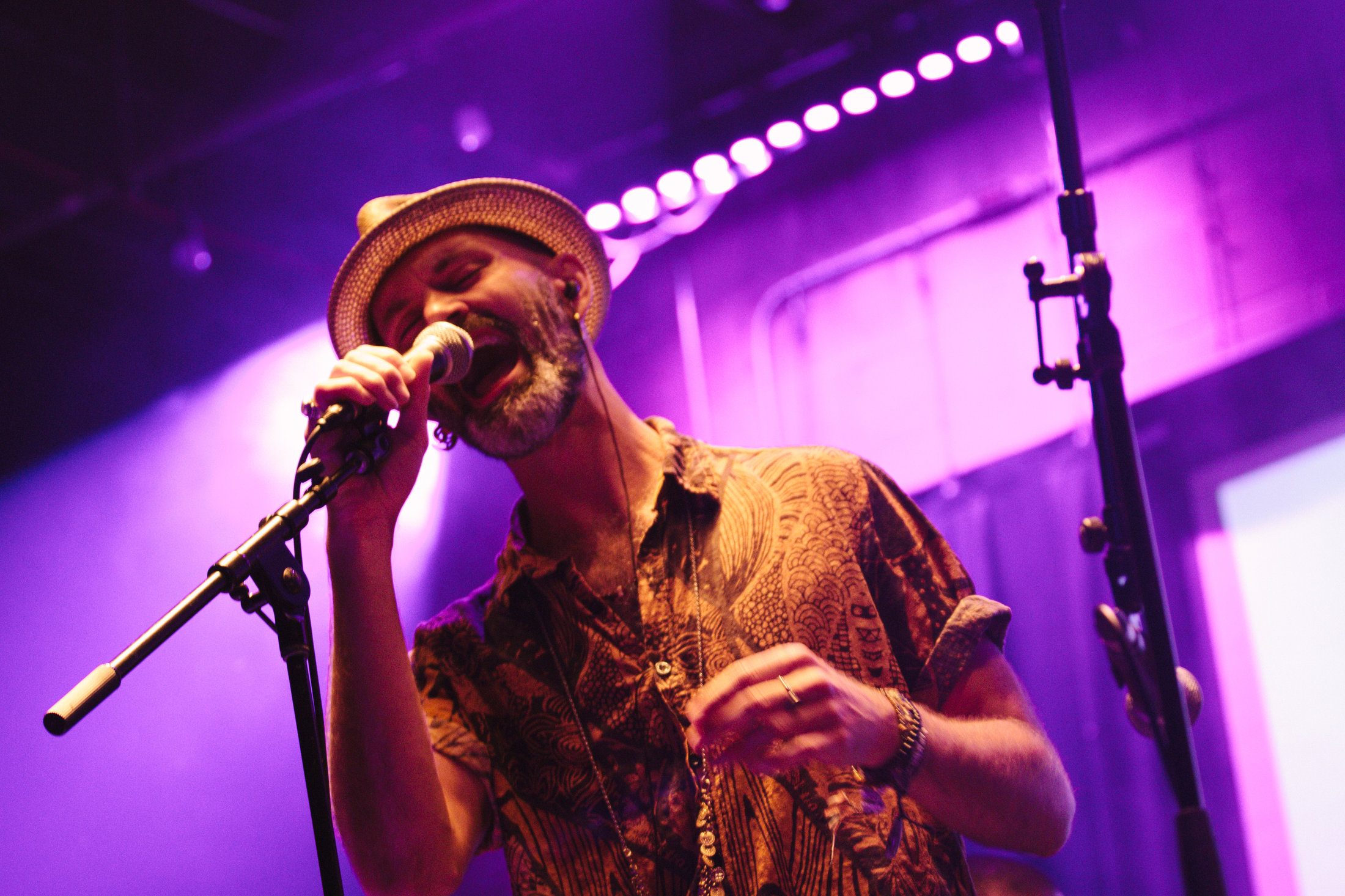 Singer on a stage lit in purple